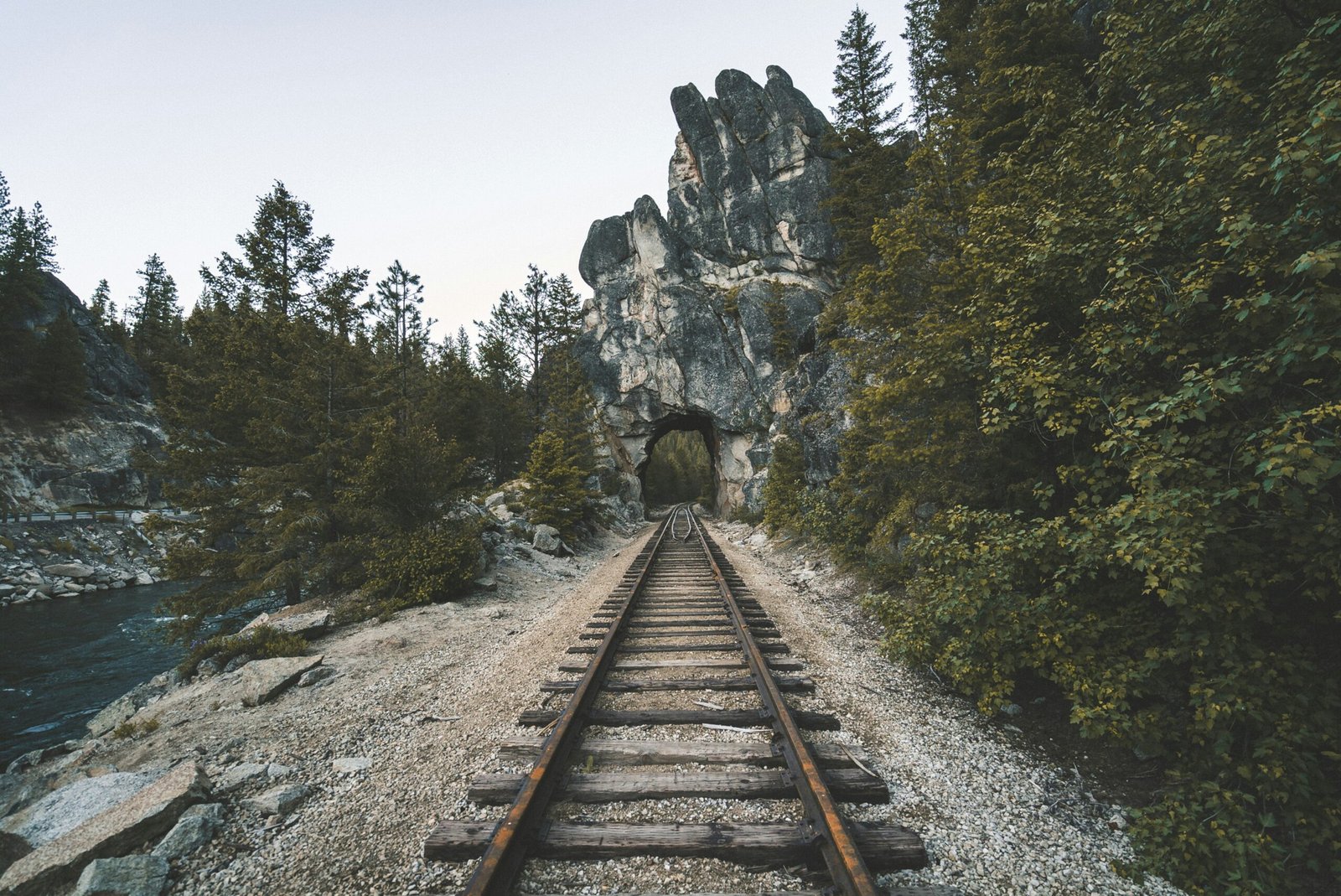 a train track going through a tunnel in the mountains