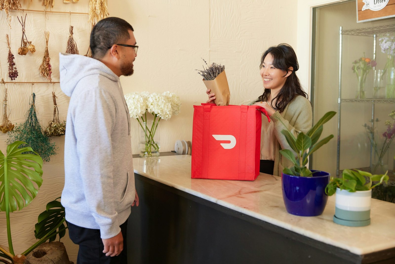 a man and a woman standing in a flower shop