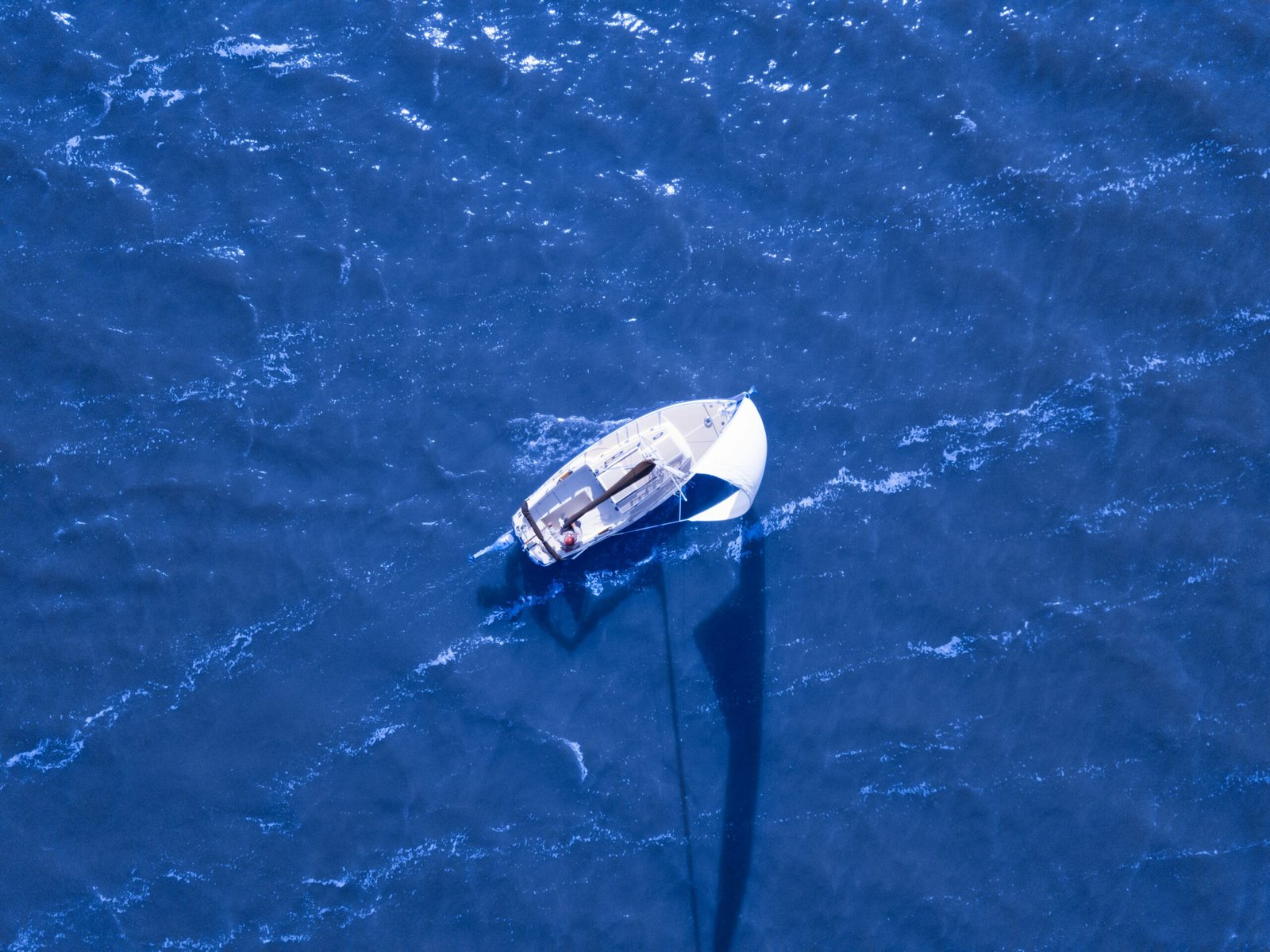 aerial view of boat sailing on blue ocean